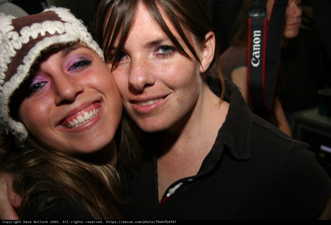 Two Friends Smiling Together at a Night Event