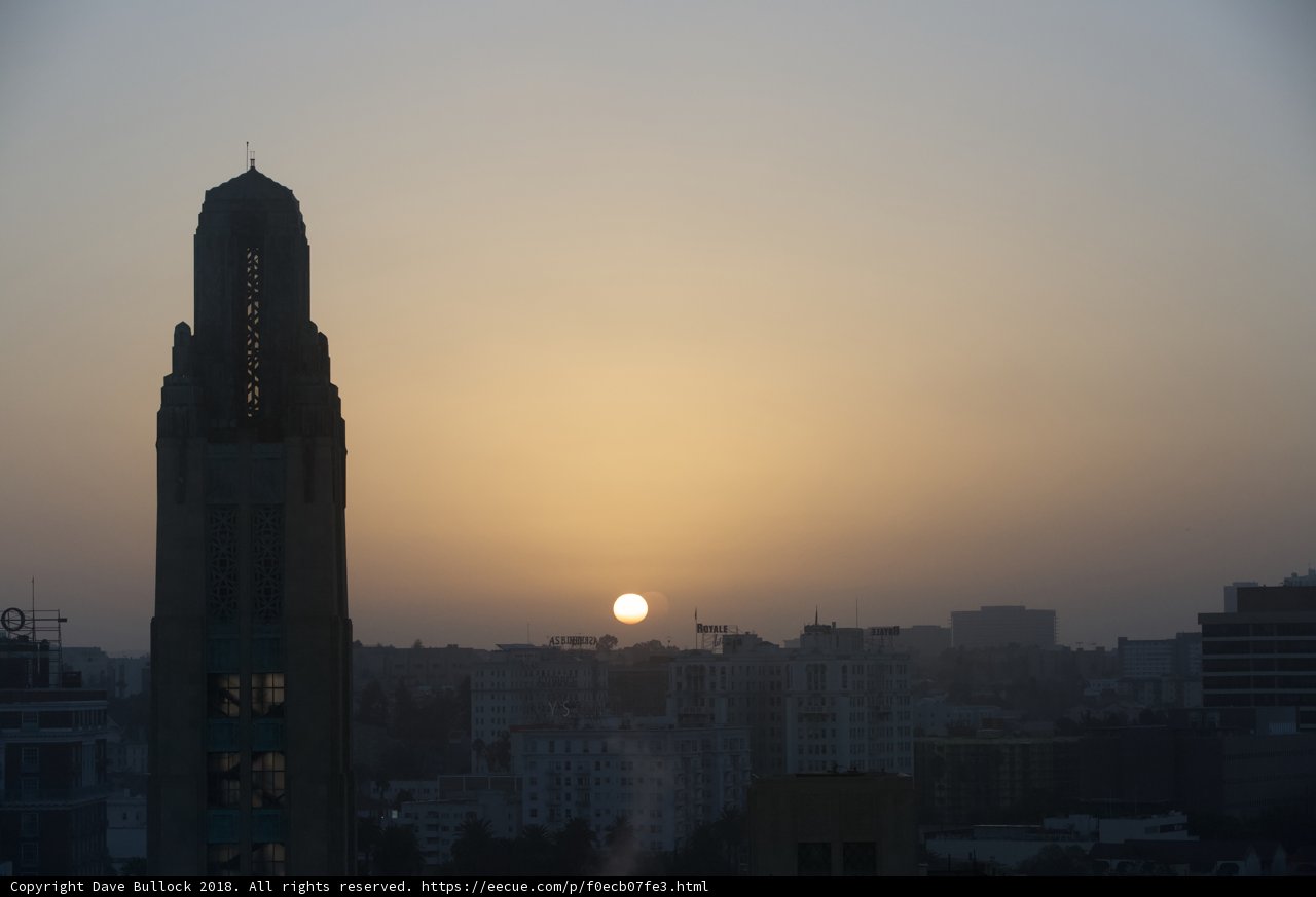 City Sunset Glows Behind Towering Skyscraper
