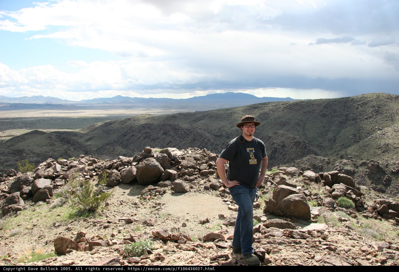 Man on Rocky Hill with Hat