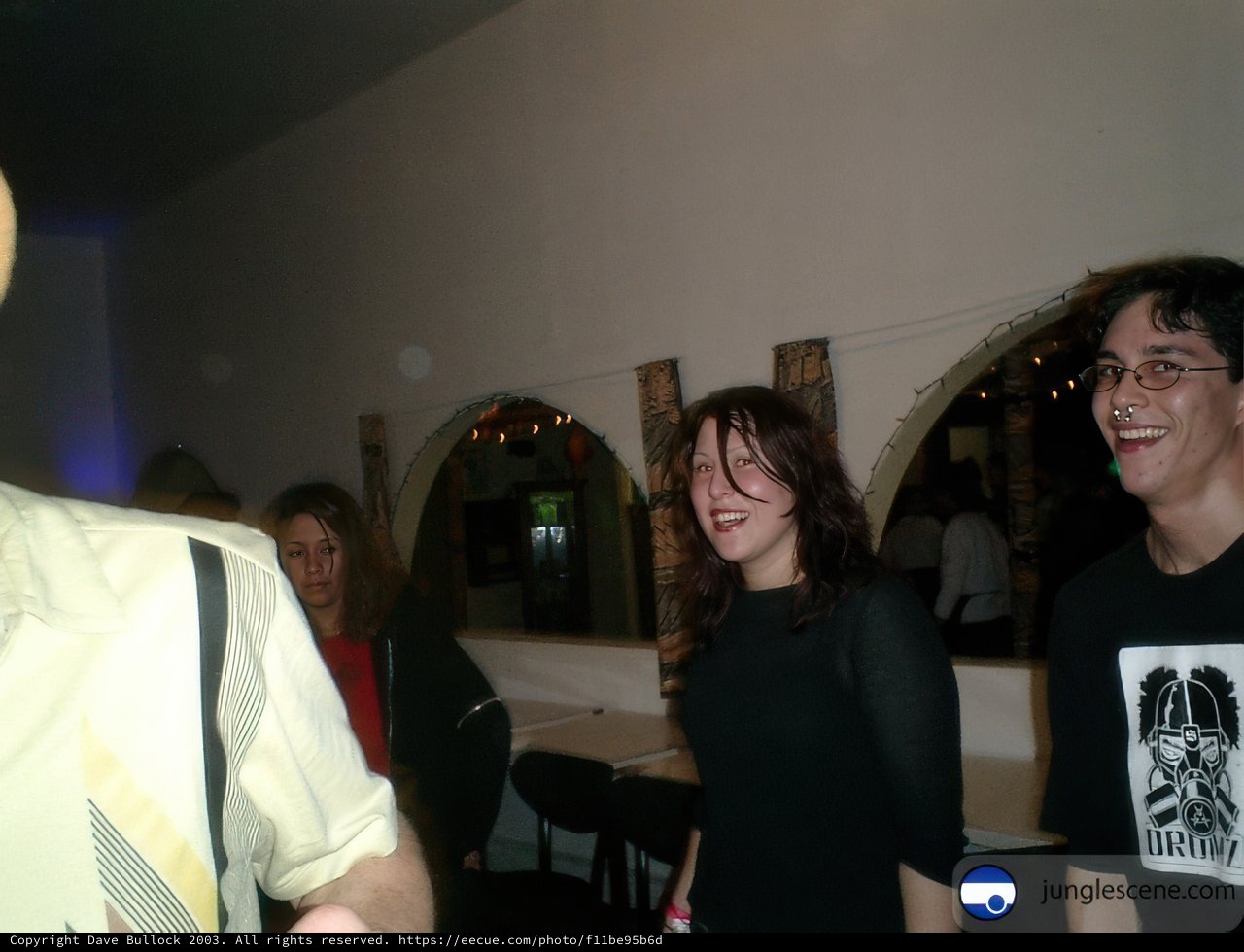 Hat-wearing man and smiling woman enjoying their dining experience