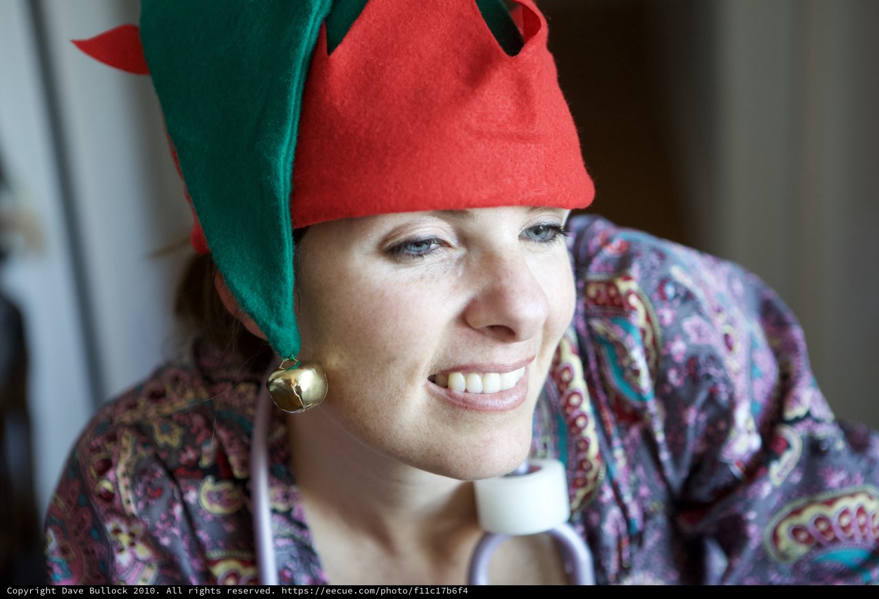 Joyful Woman in Christmas Elf Hat Smiling Warmly