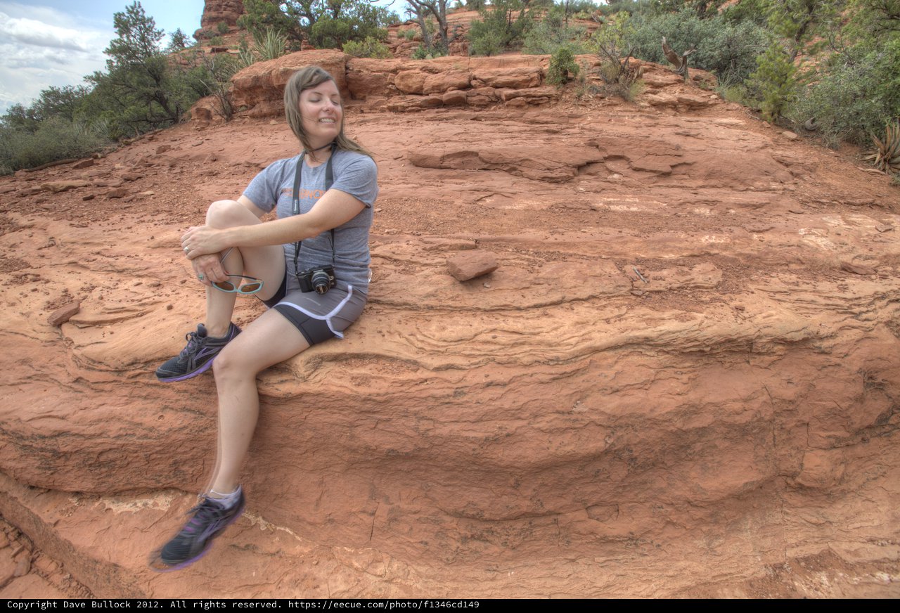 Hiker Resting on Red Rock Formation in Sedona