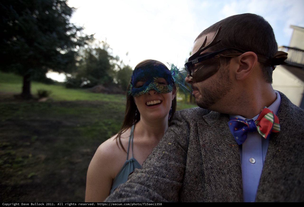 Masquerade Couple Laughing at Outdoor Wedding Celebration