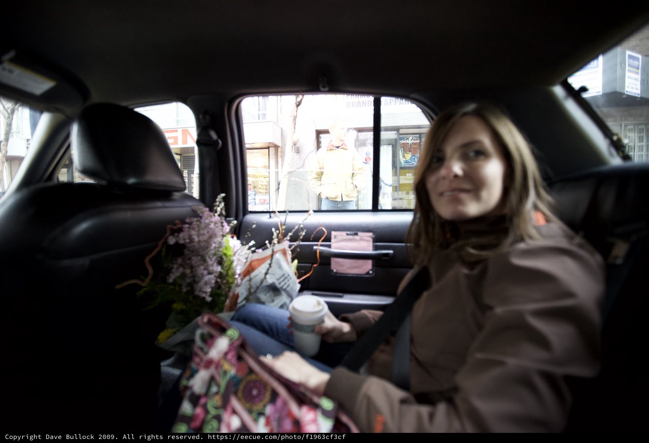 Woman in Taxi with Flowers on Valentine's Day