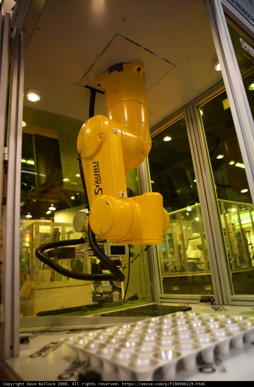 Yellow Robot in a Manufacturing Machine