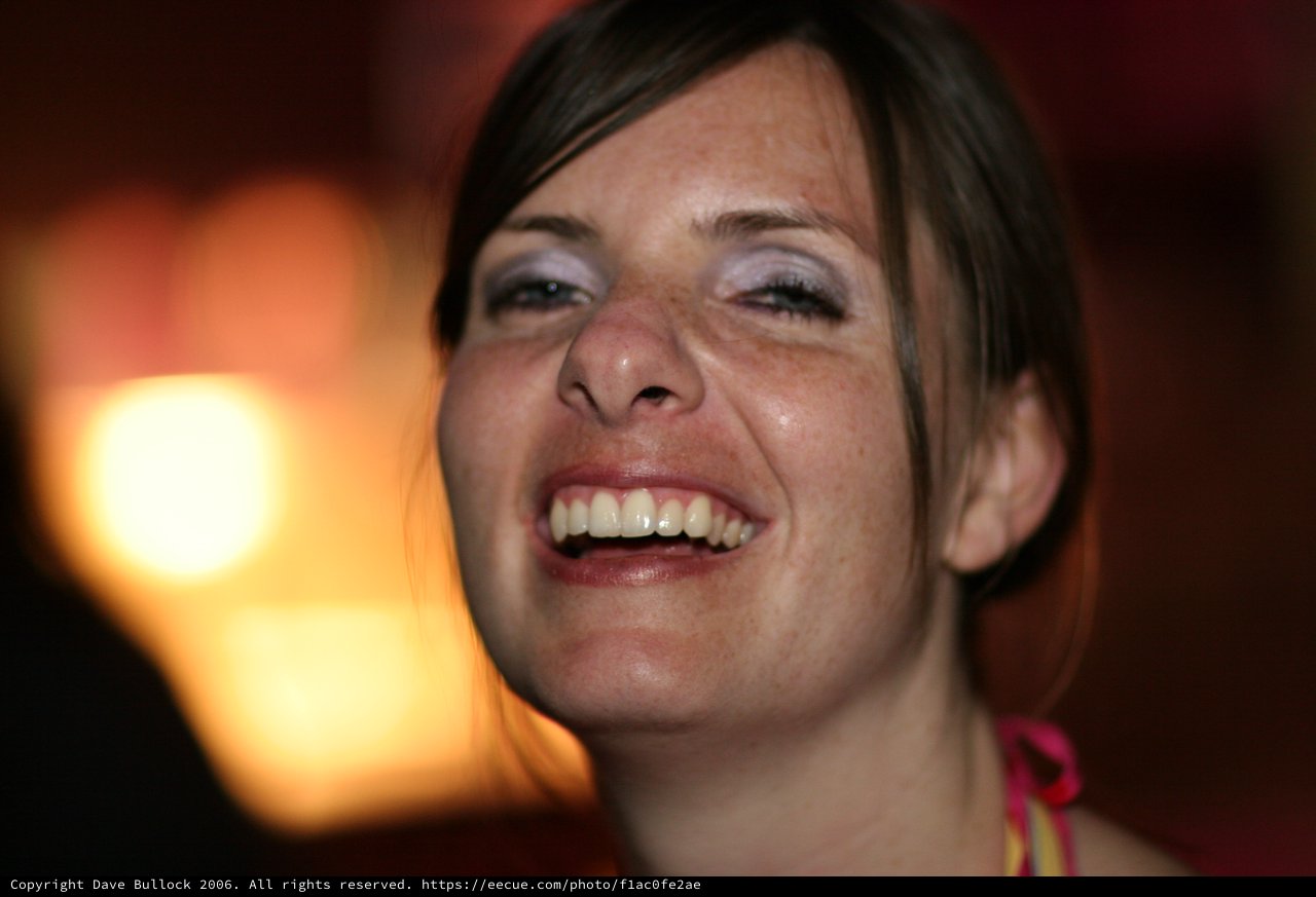 Joyful Woman Laughing in Warm Ambient Light