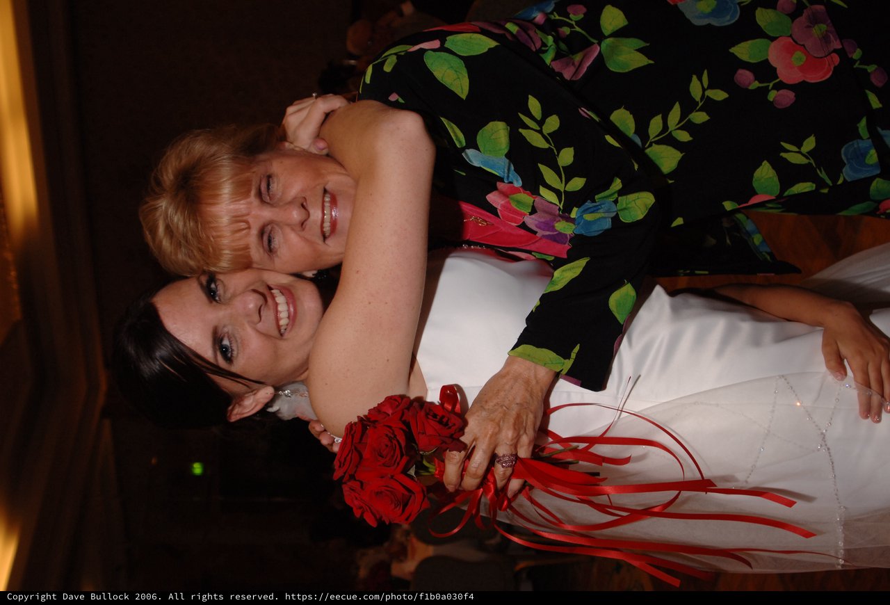 Bride and Guest Share Joyful Wedding Embrace