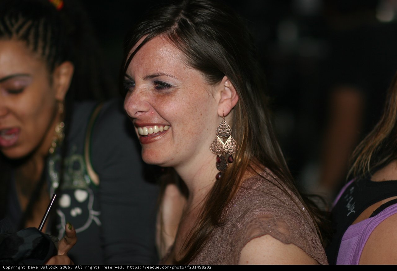 Woman Laughing Joyfully at Nighttime Social Event