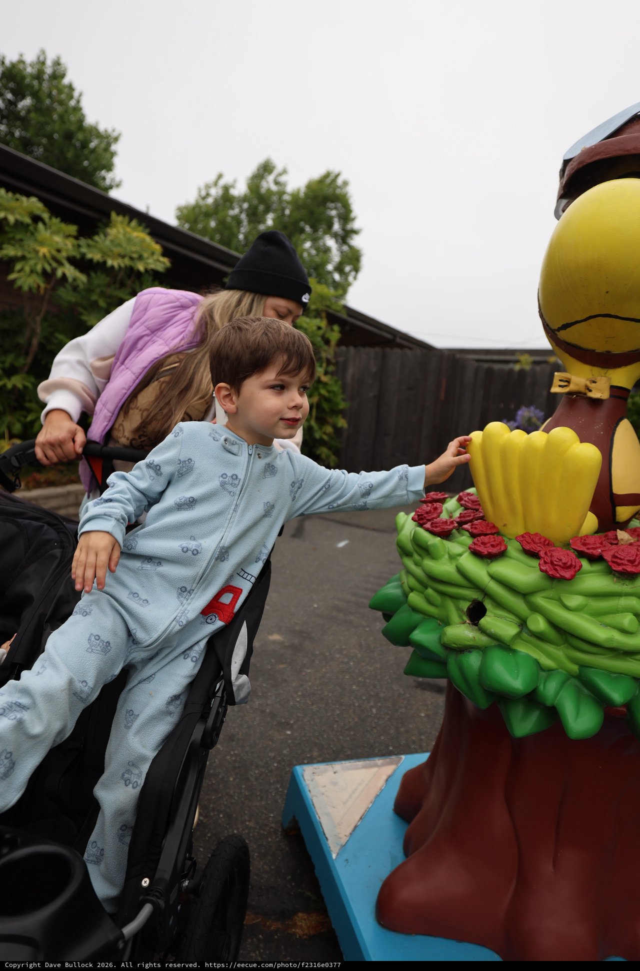Curious Boy Reaches Out to Touch Colorful Statue