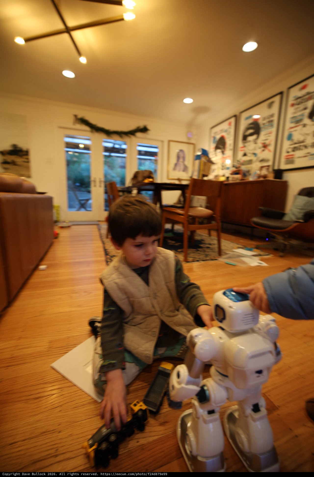 Child Playing with Robot Toy in Cozy Living Room