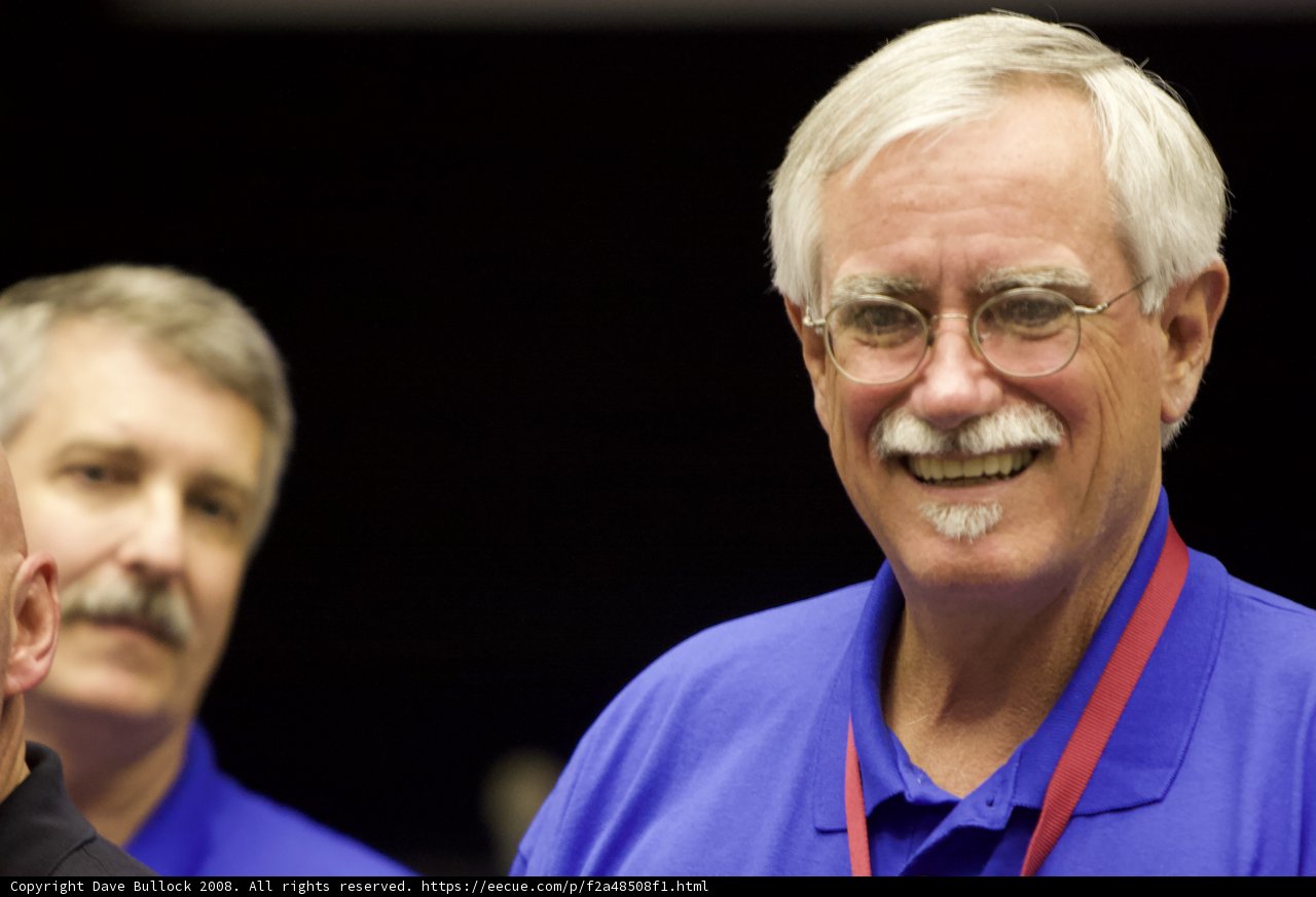 The Smiling Man with Glasses