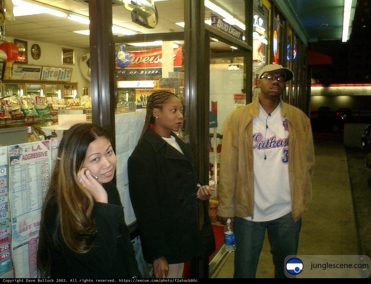 Three People Outside Convenience Store