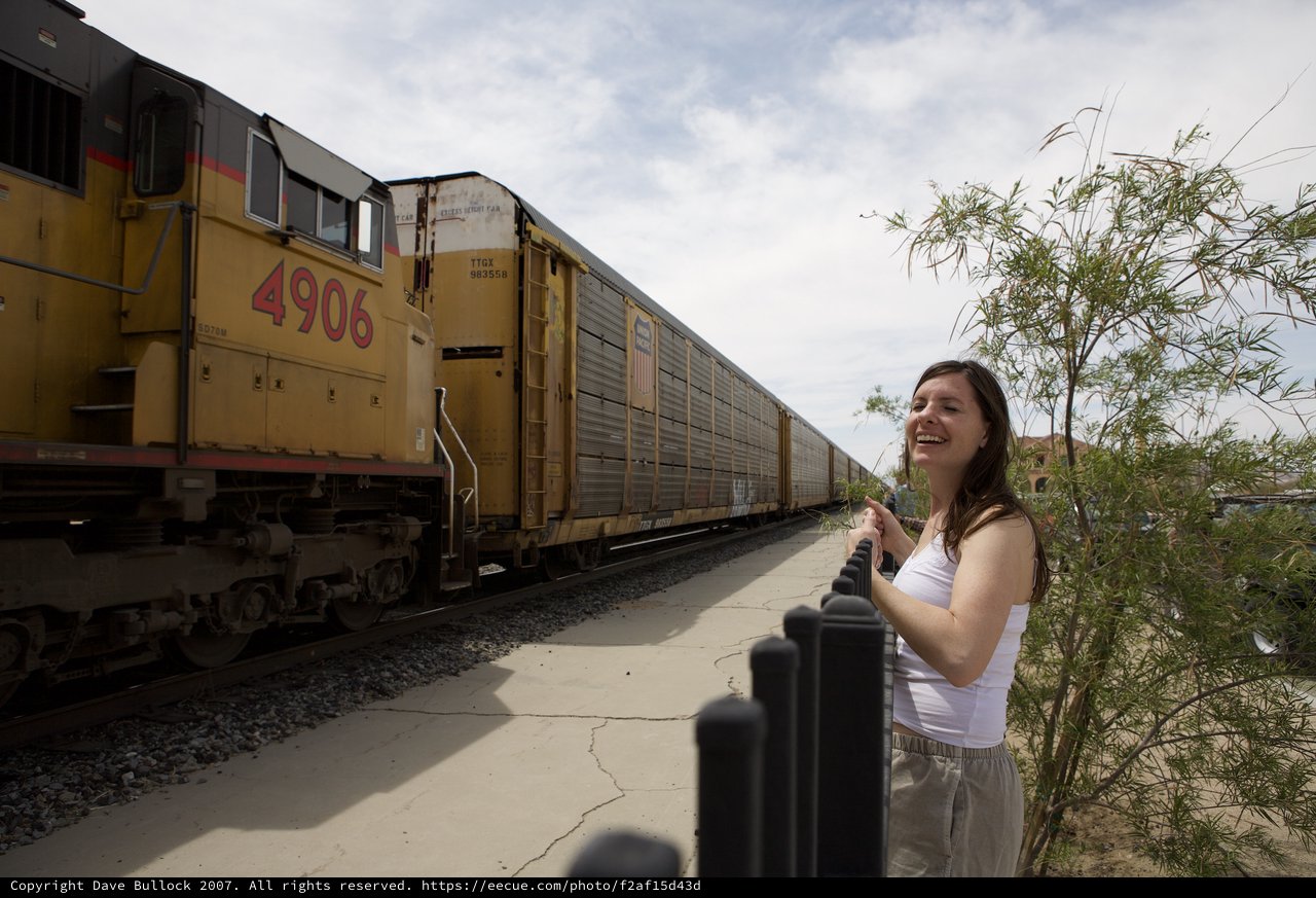 Joyful Woman Laughing Beside Union Pacific Freight Train