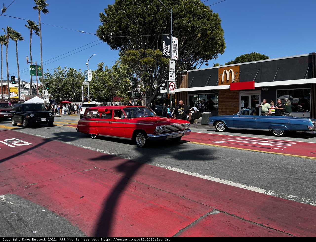 Red Coupe Parked at Busy Intersection