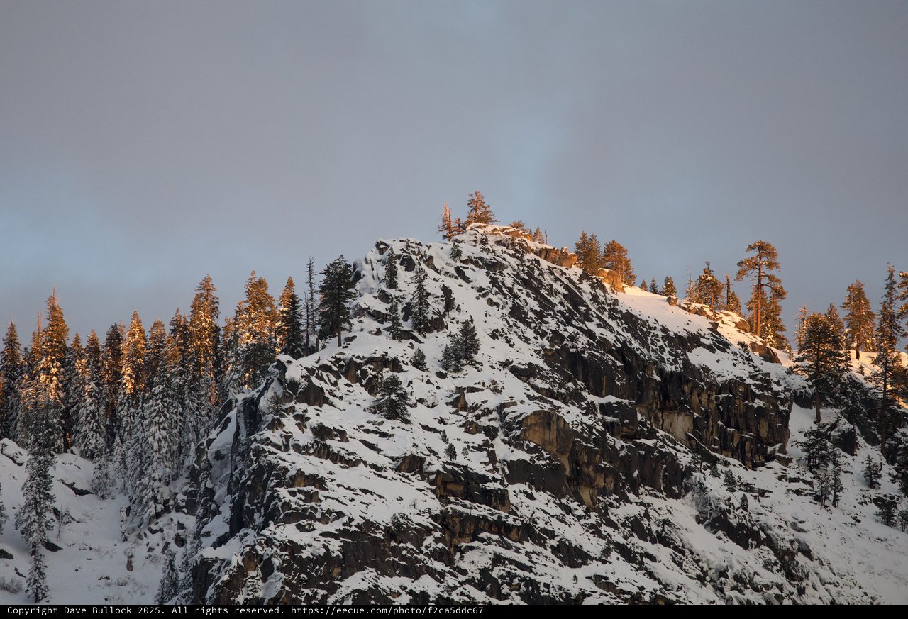 Snow-Covered Rocky Summit at Golden Hour in Winter