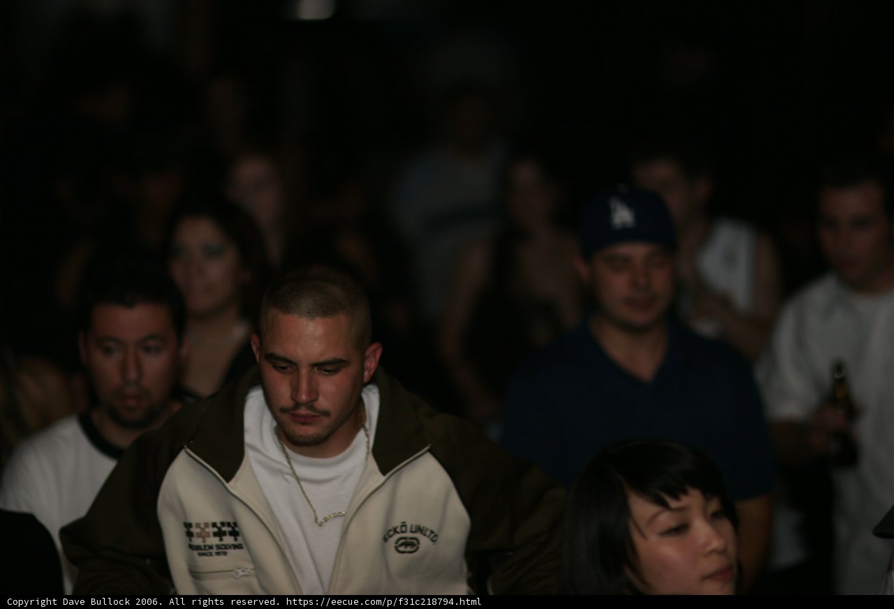 White Shirted Man in Urban Crowd