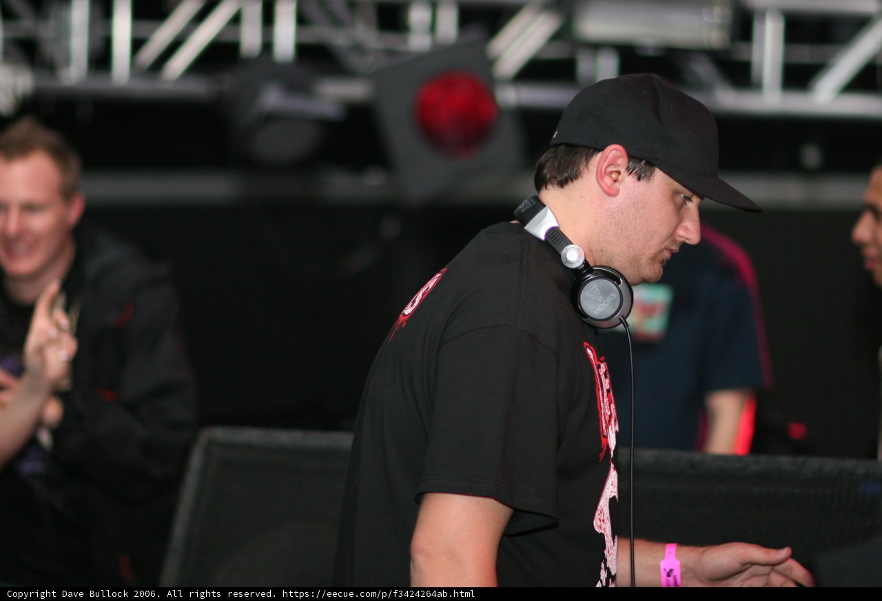 Black-Shirted DJ Amongst Enthusiastic Crowd