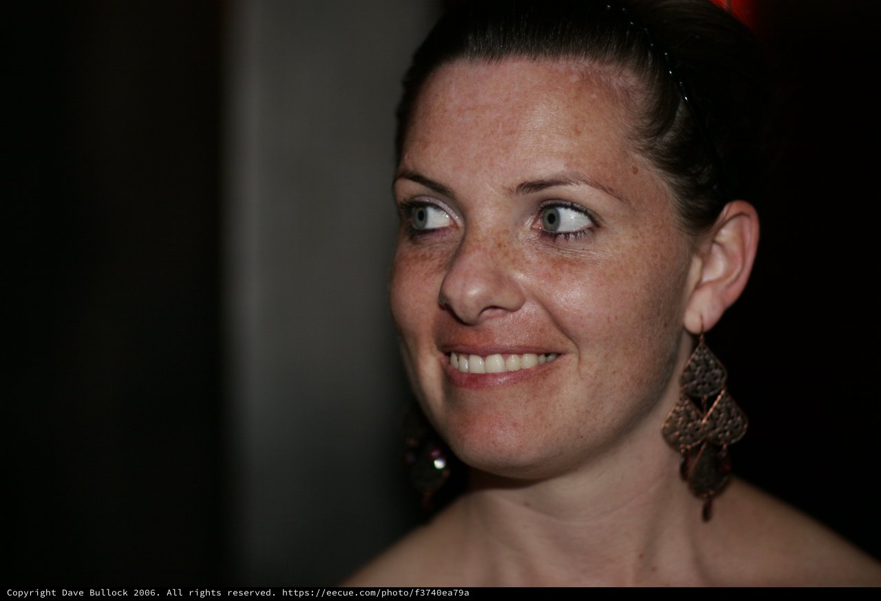 Freckled Woman Smiling Candidly at Evening Event