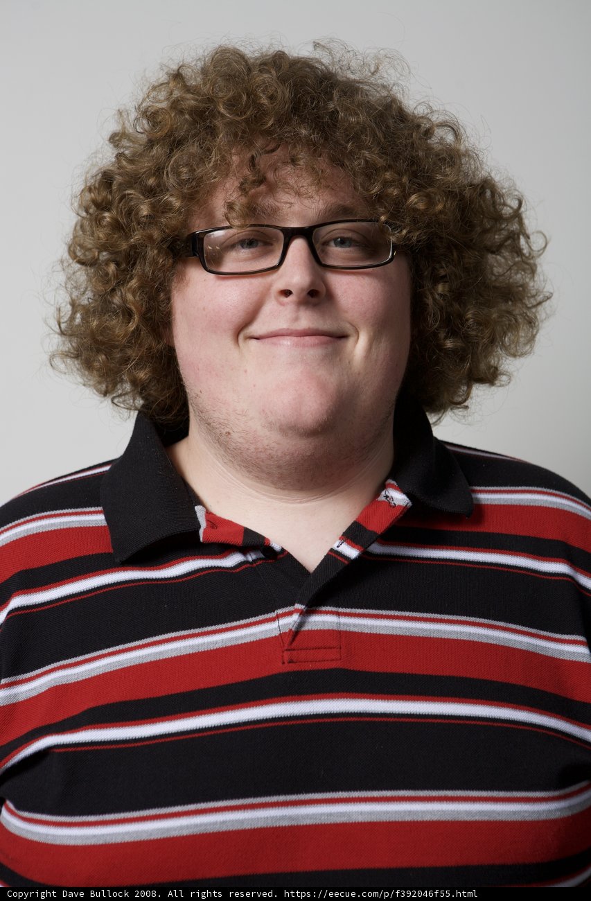 Happy Man with Curly Hair and Glasses