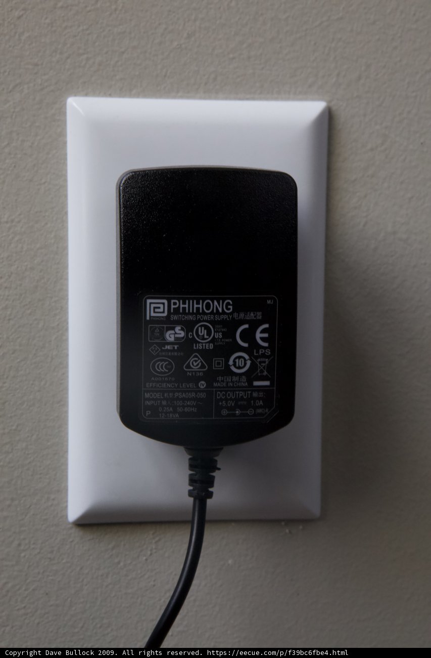 Power Plug Connected to Wall Outlet