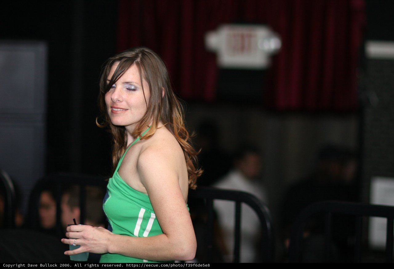 Elegant Woman in Green at Evening Indoor Event