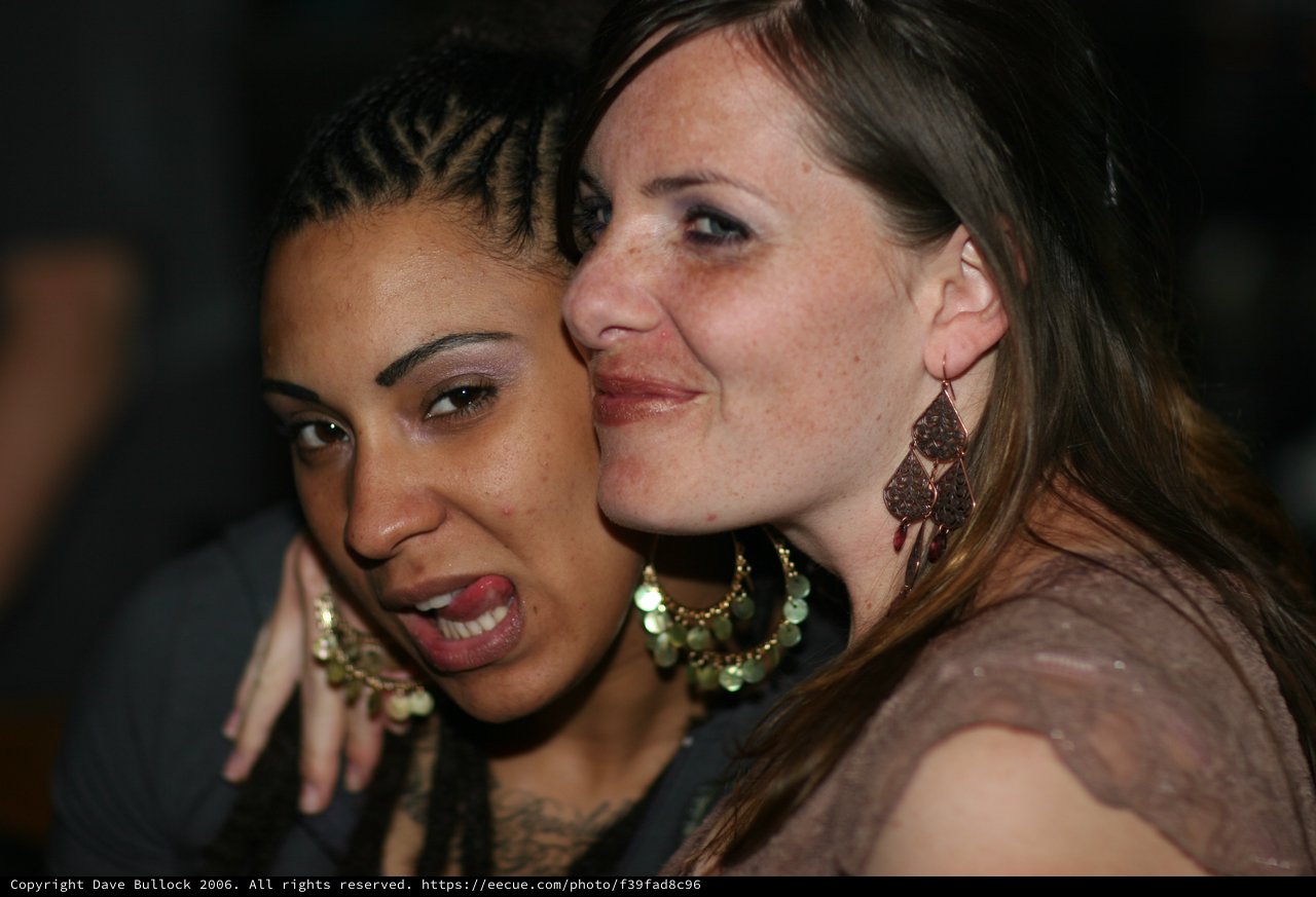 Two Friends Sharing a Playful Moment at Night Event
