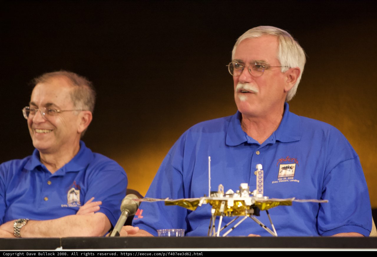 Two Men in Blue Shirts Sitting at Phoenix Landing Press Conference