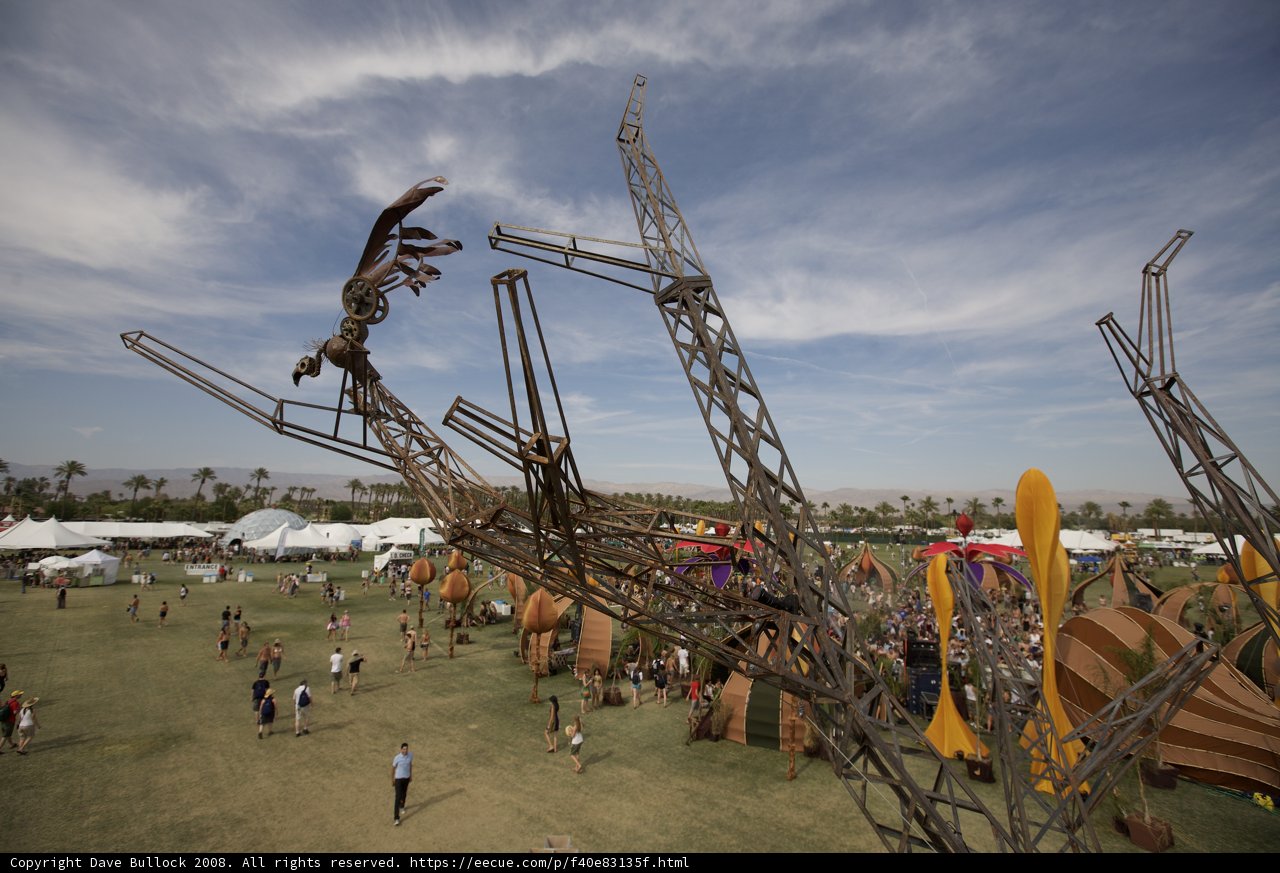 Majestic bird sculpture standing tall amidst the grassy field