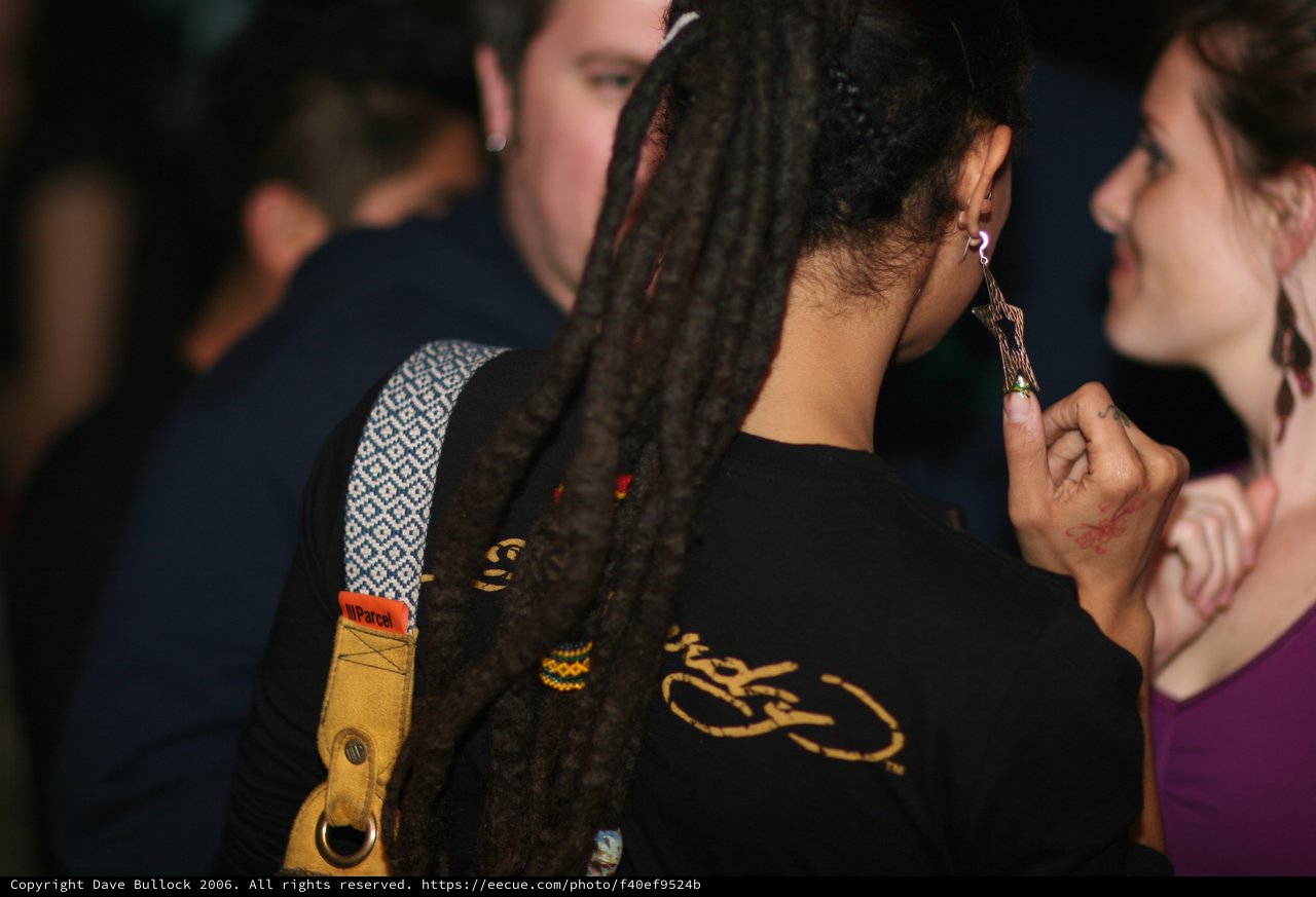 Dreadlocks and Conversation at a Nighttime Gathering