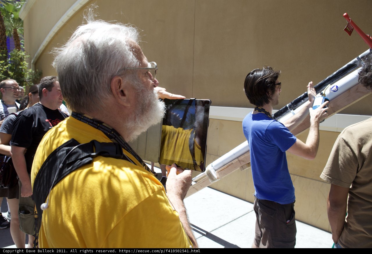 Tablet in Hand, Crowd in Sight