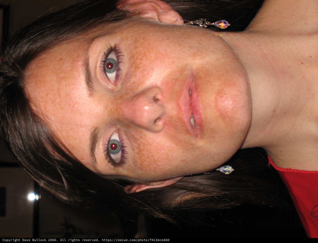 Freckled Woman in Red with Crystal Earrings