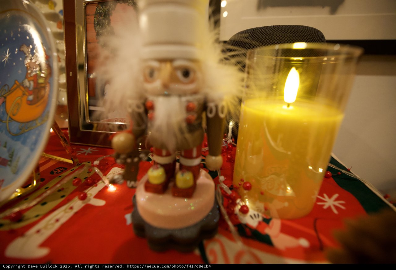 Festive Holiday Display with Nutcracker and Glowing Candle