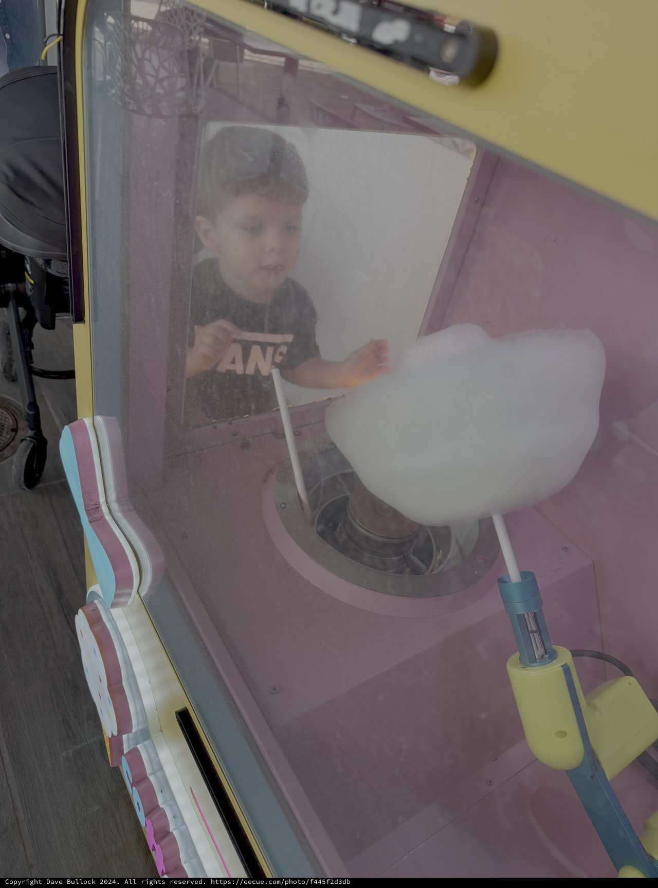 Child Enjoying Cotton Candy at Amusement Park