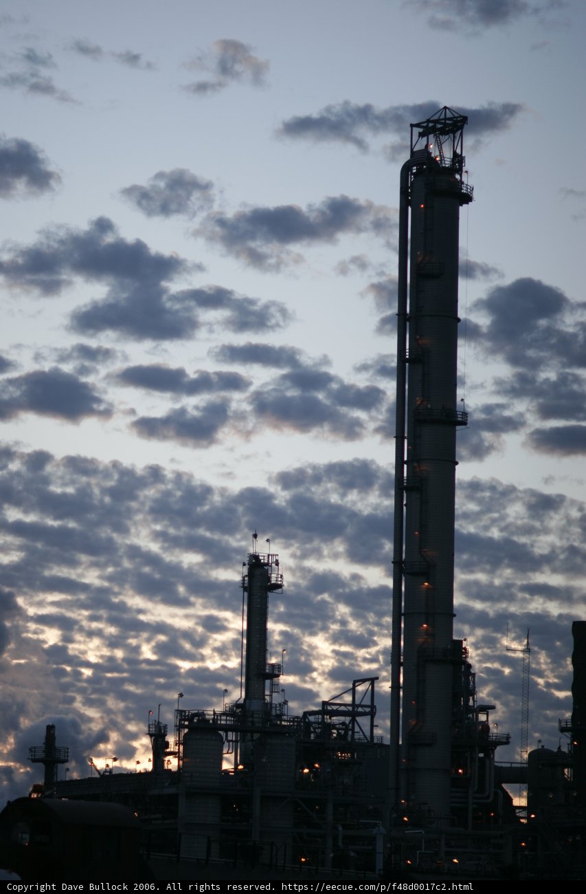 Towering Refinery under Cloudy Skies