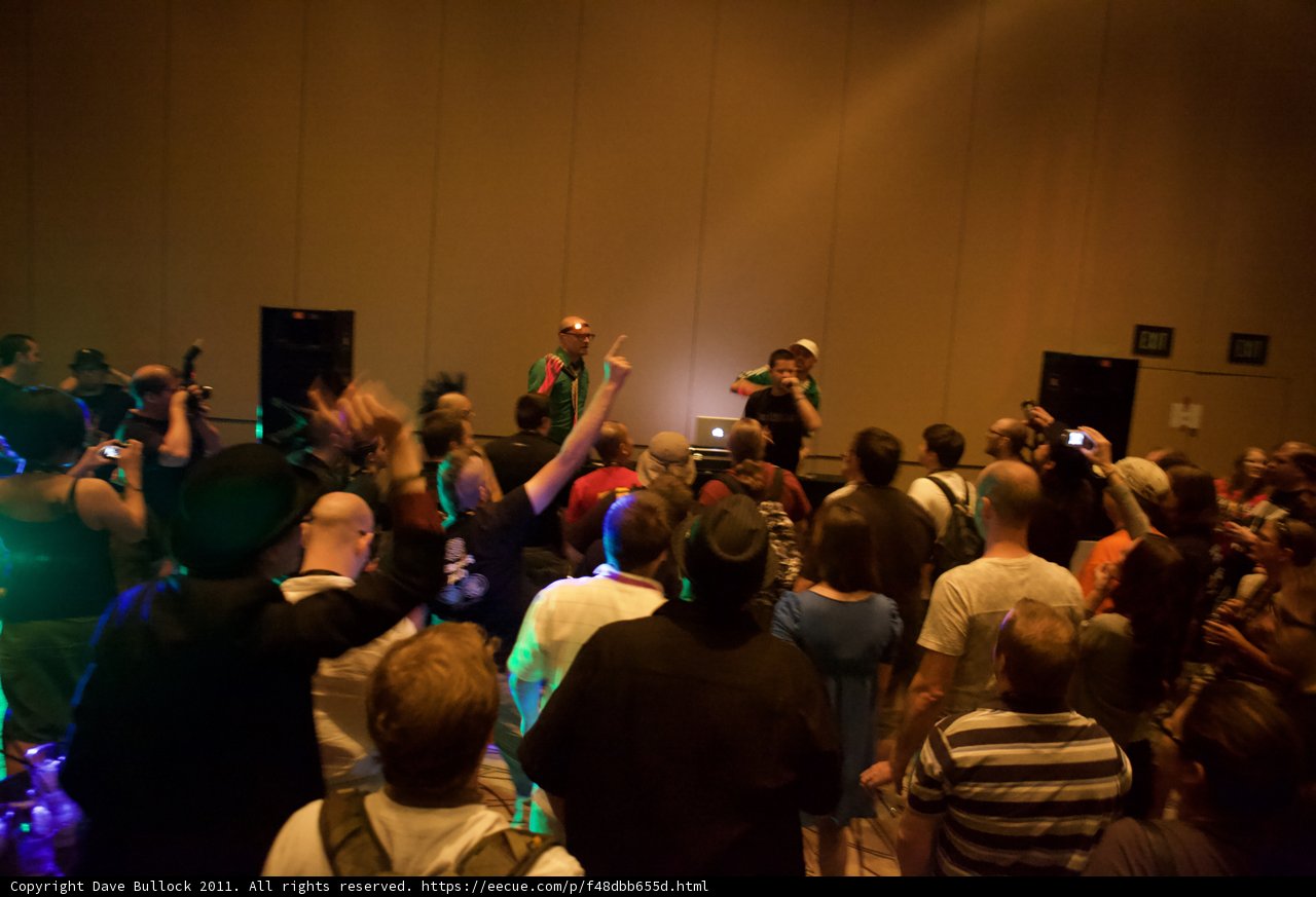 Crowd at Defcon Convention with Hat-Wearing Man