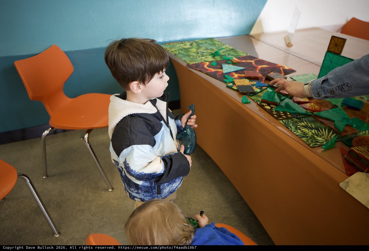 Young Boy Engaged in Interactive Museum Learning Activity