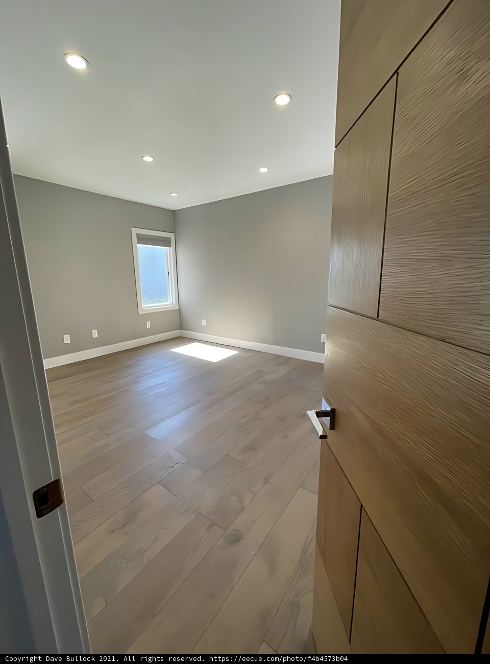 Welcoming Foyer with Stained Hardwood Floors