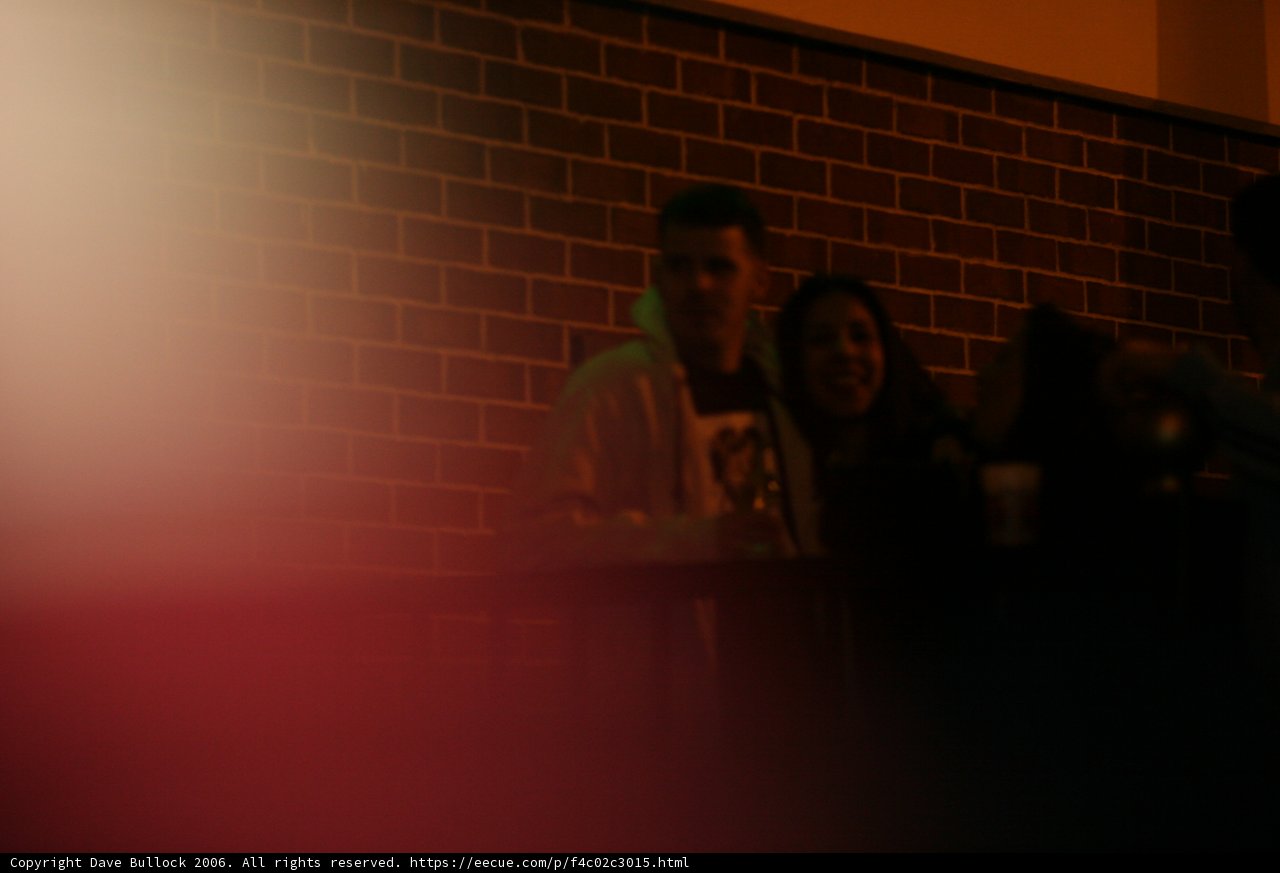 Blurred Faces in Brick Wall
