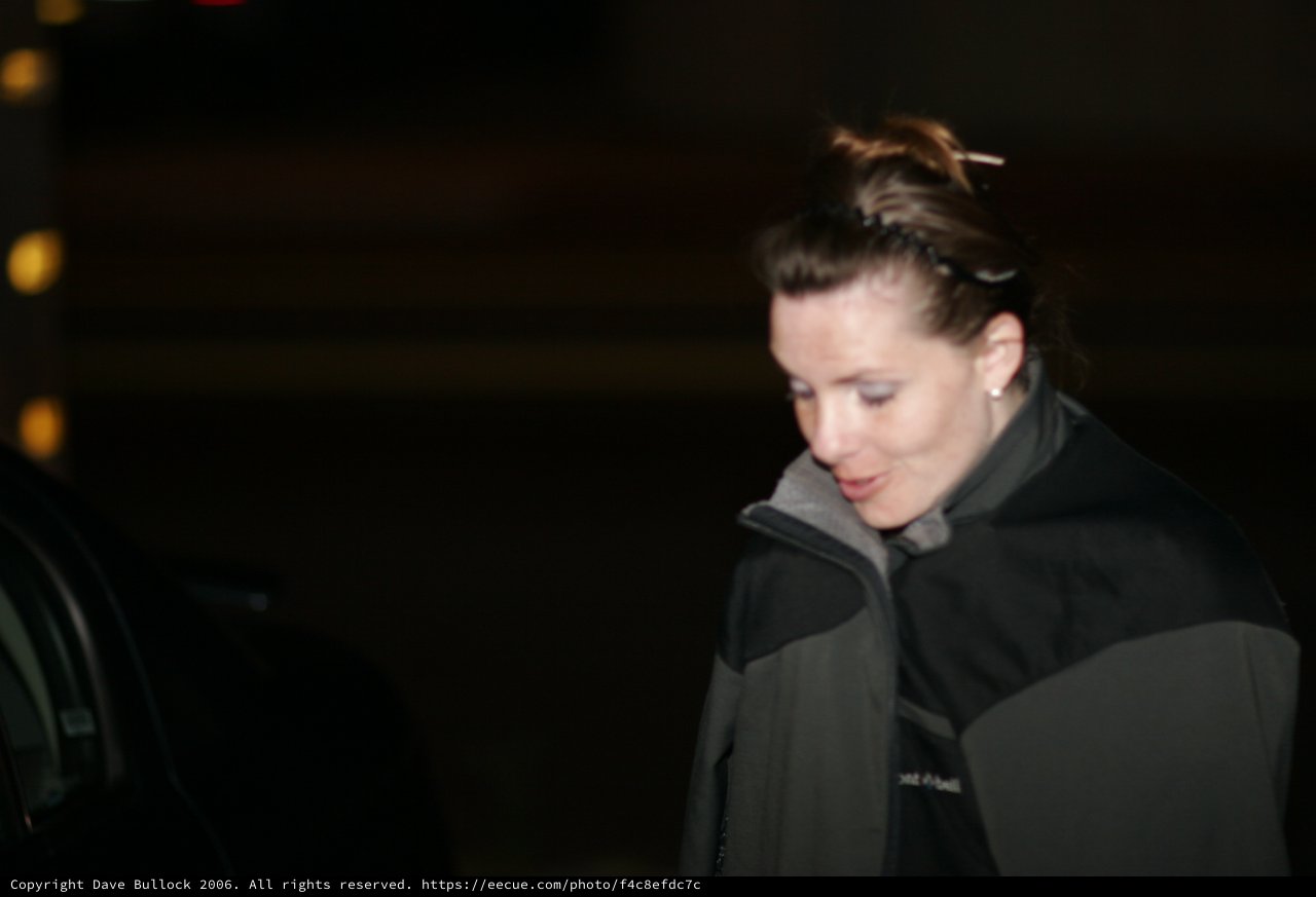 Woman in Dark Jacket Looking Down at Night