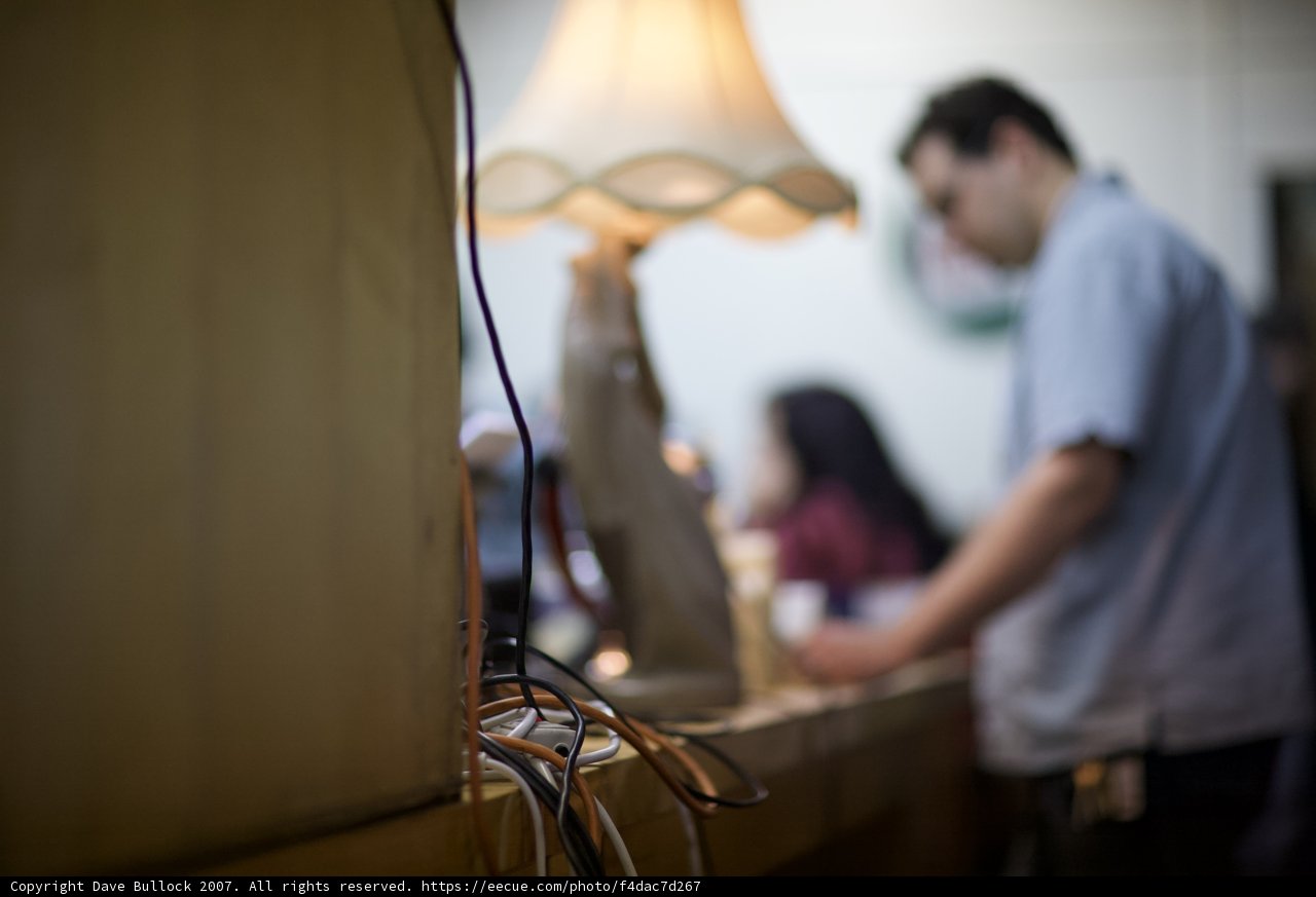 Man with Table Lamp on Plywood Counter