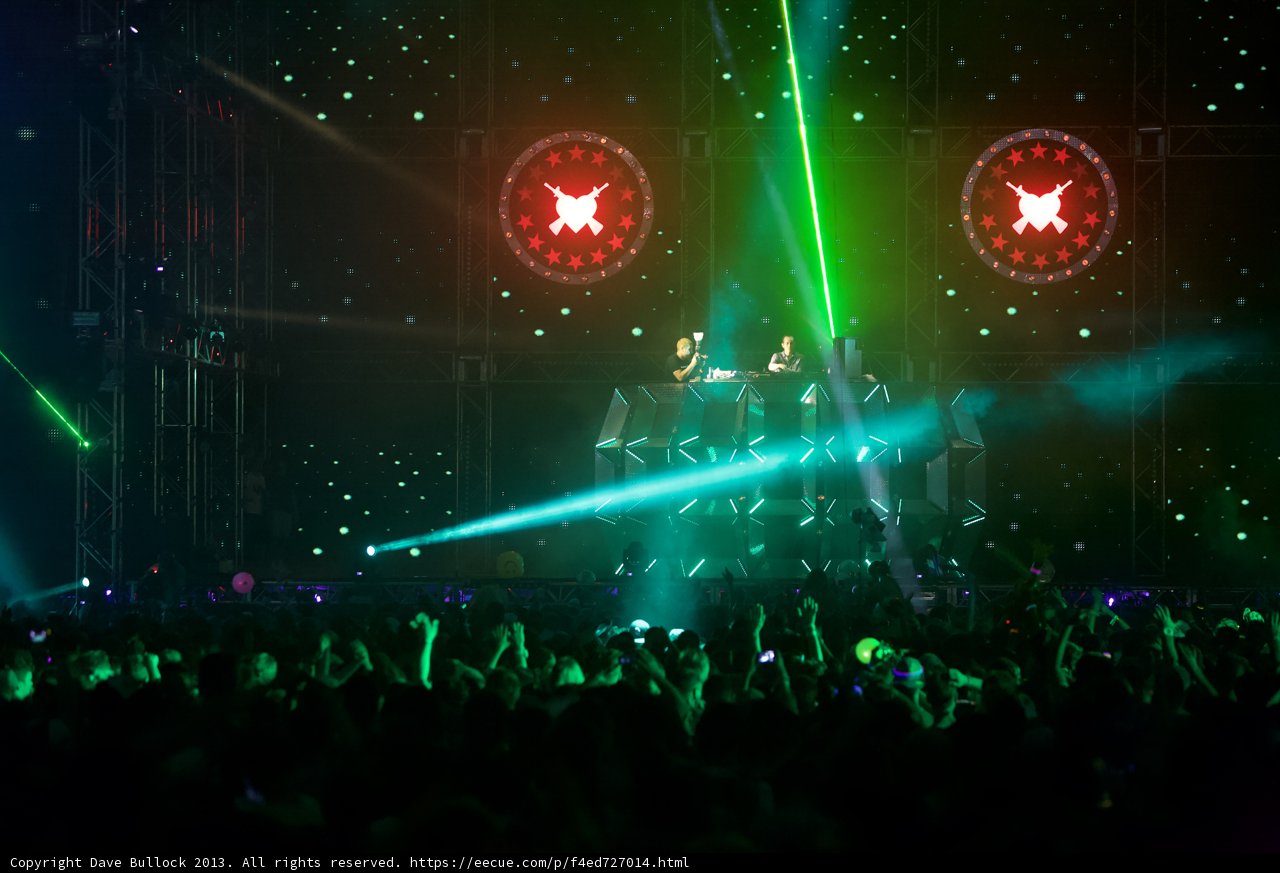 Green Spotlight on Rock Concert Crowd