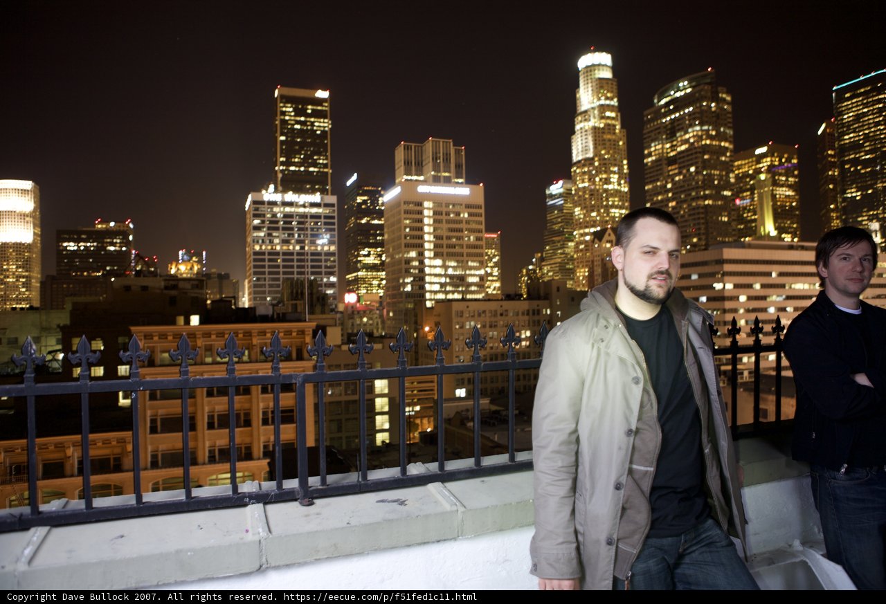 Two Men Overlooking the Urban Metropolis at Night