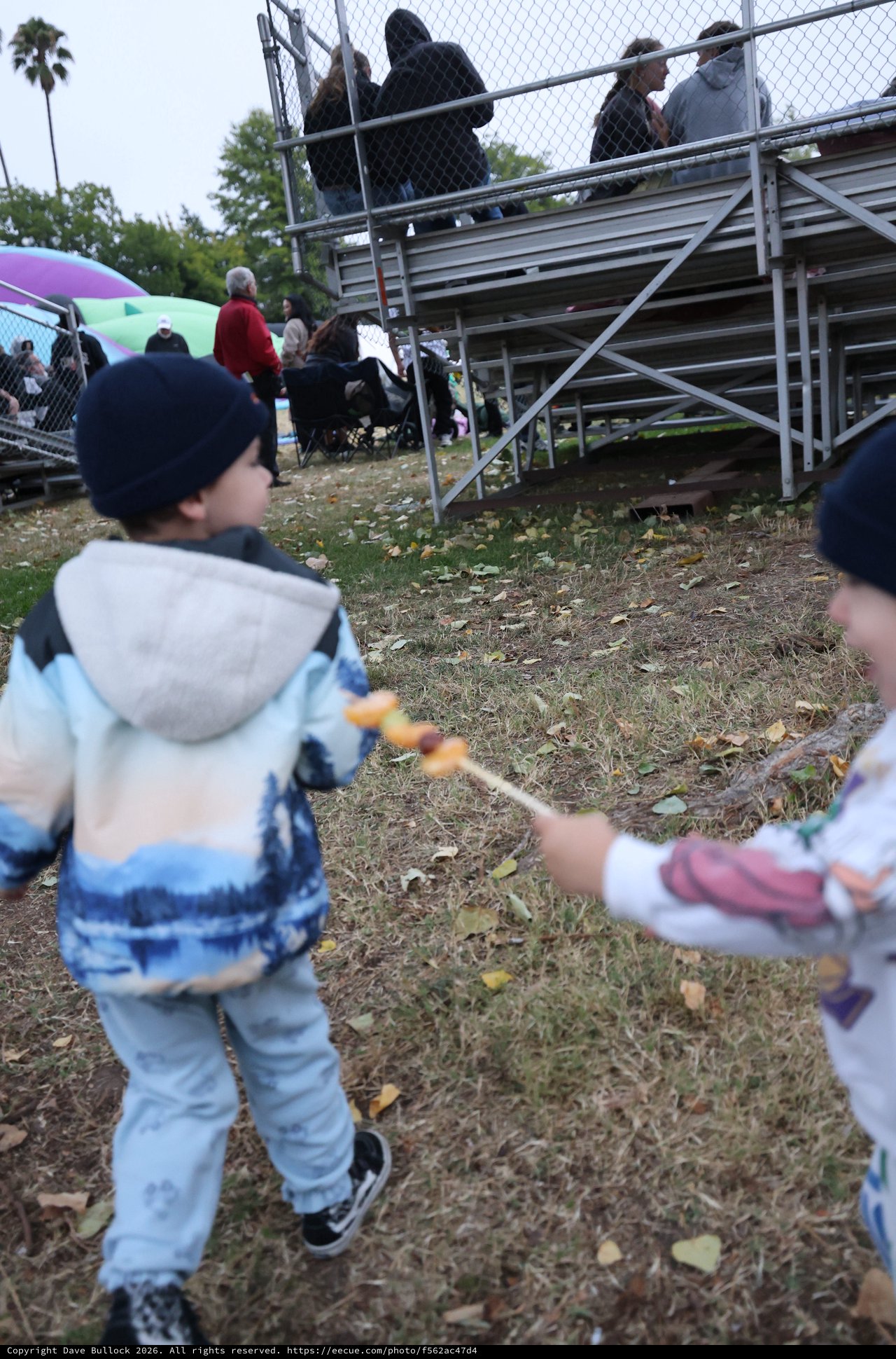 Children Playing with Skewered Snacks at Balloon Festival