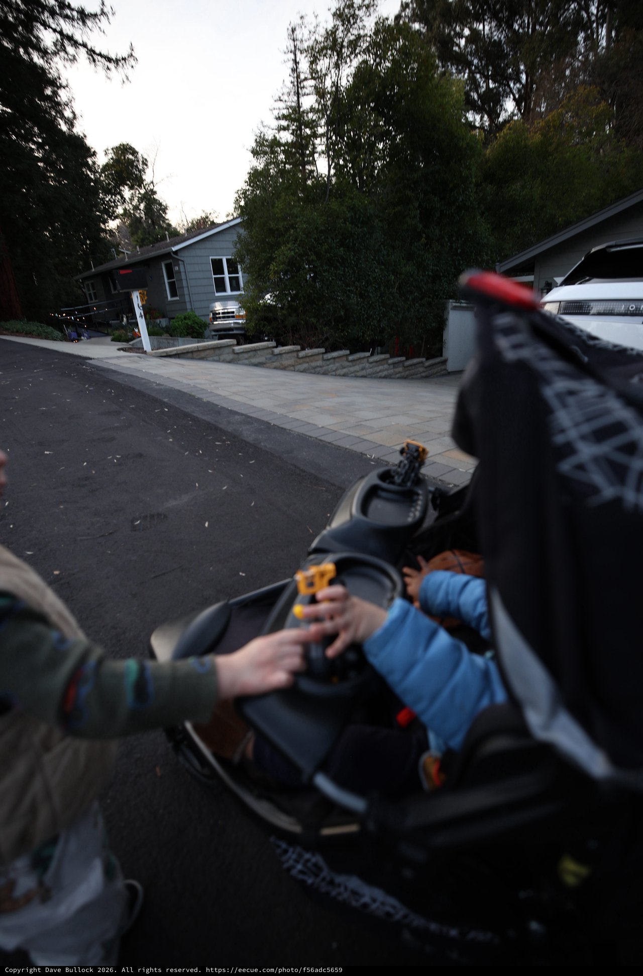 Evening Stroll with Baby in Residential Driveway