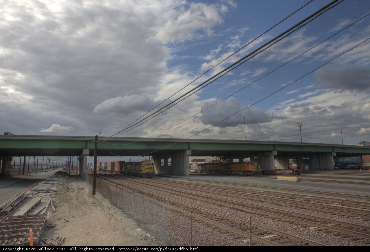 Train Passing Under Overpass