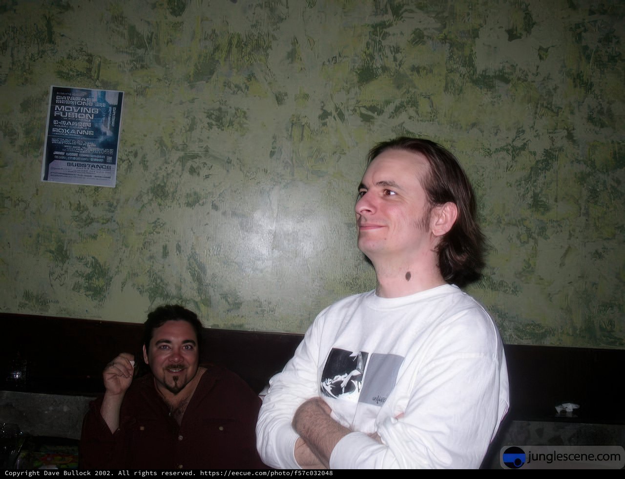 Two Men Posed in Front of Wall