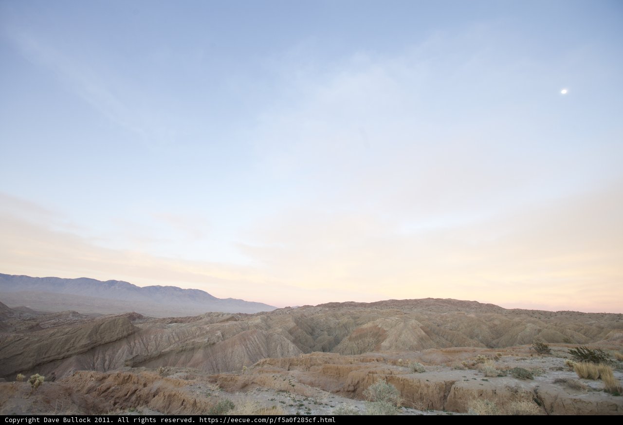 Desert Sunset with a Moon in the Sky