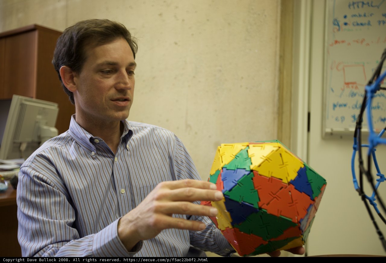 Colorful Sphere in the Hands of a Man