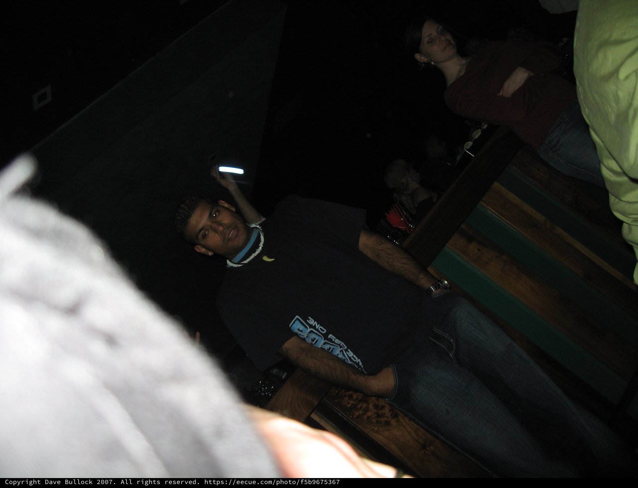 Young Man at Nightclub Poses in Dark Venue