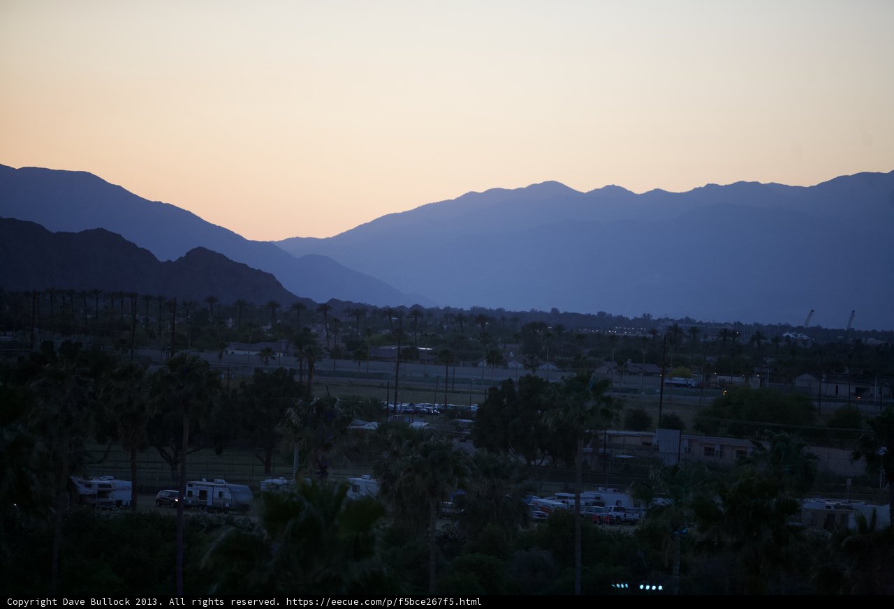 Sun Setting over Majestic Mountains & Palm Trees